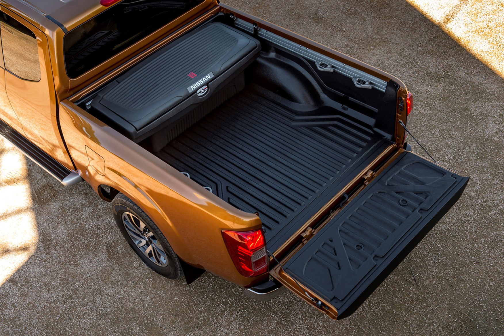 Nissan Navara top-down view of load bed with tailgate lowered, orange