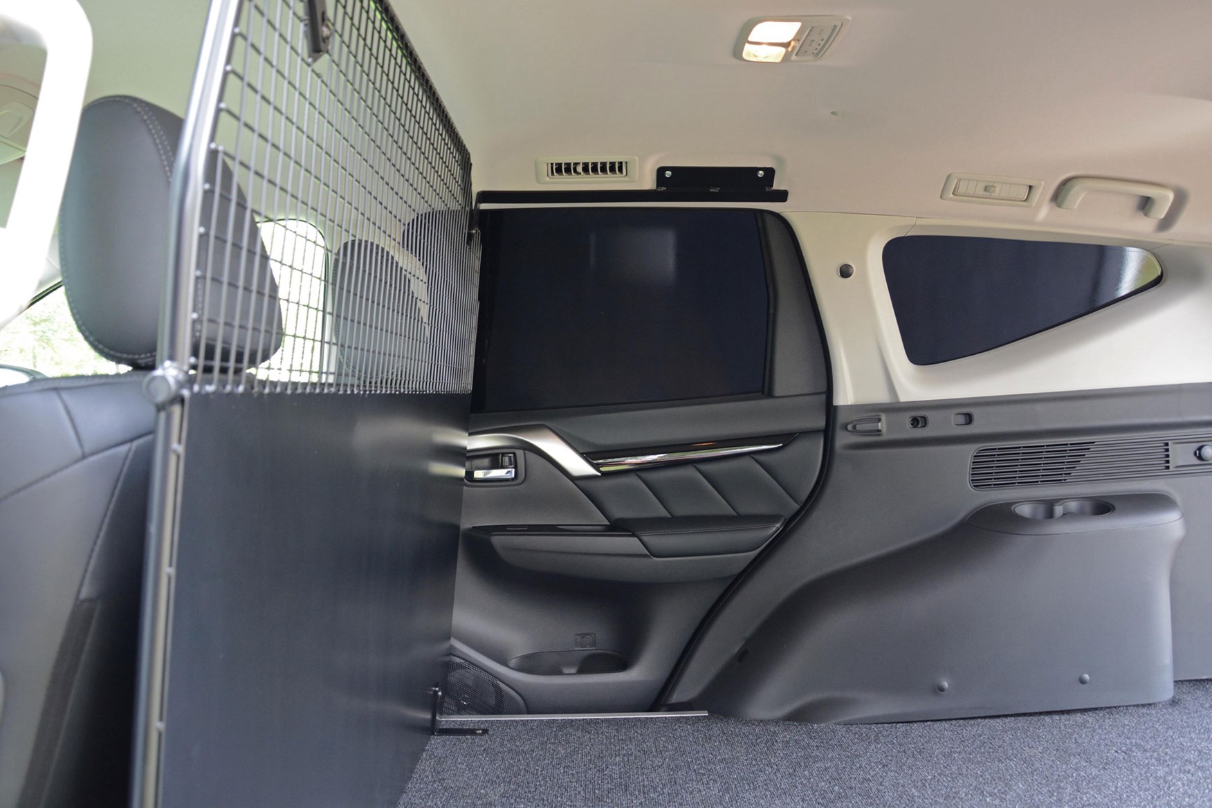 Mitsubishi Outlander Commercial 4x4 van - inside load area showing rear door trim panel from passenger car