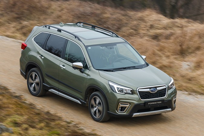 Subaru Forester (2022) review - front pan shot, green car, dirt road