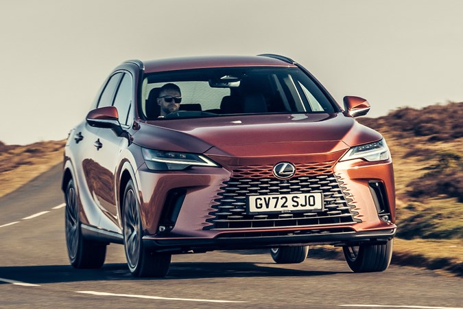Lexus RX 450h+ (2023) review: front three quarter cornering hard, bronze car, country road