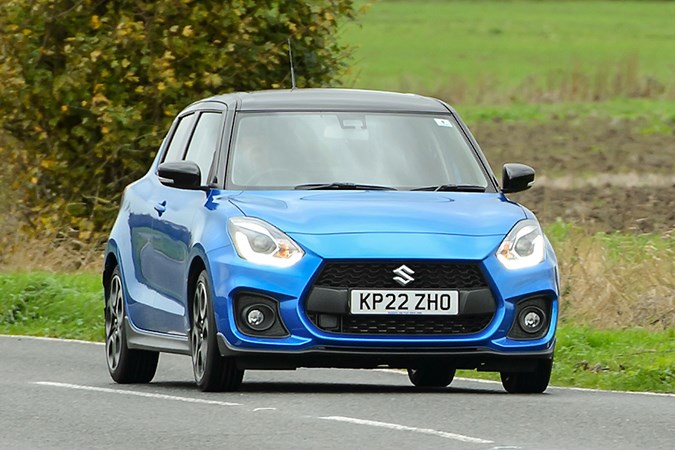 Suzuki Swift Sport (2023) review: front three quarter cornering, blue car, British B-road