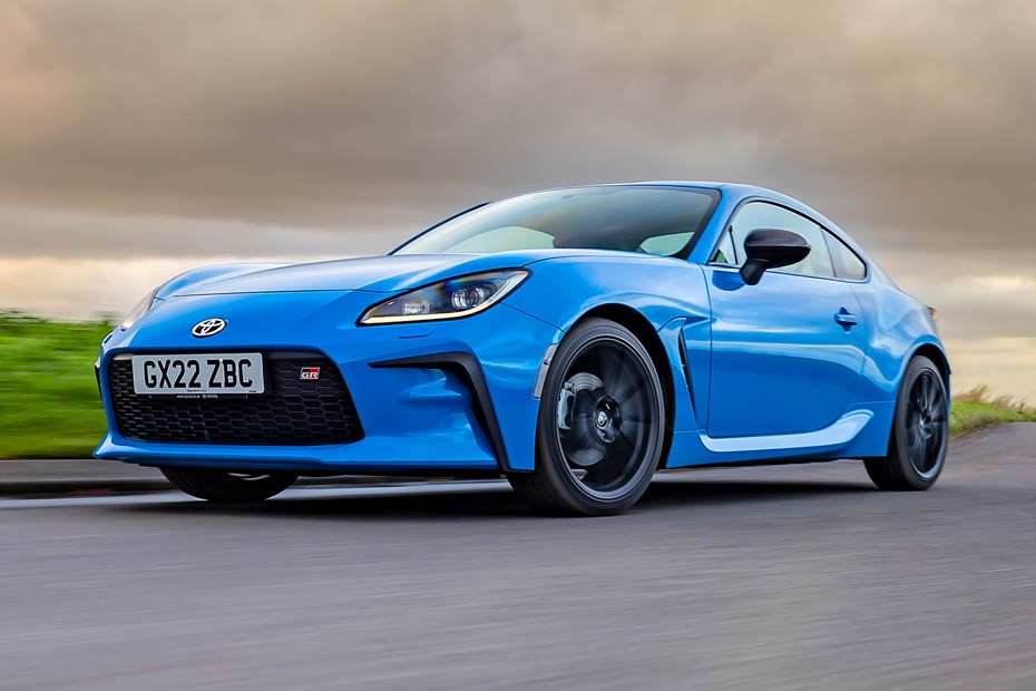 Toyota GR86 review: front three quarter tracking driving, low angle, country road, blue paint