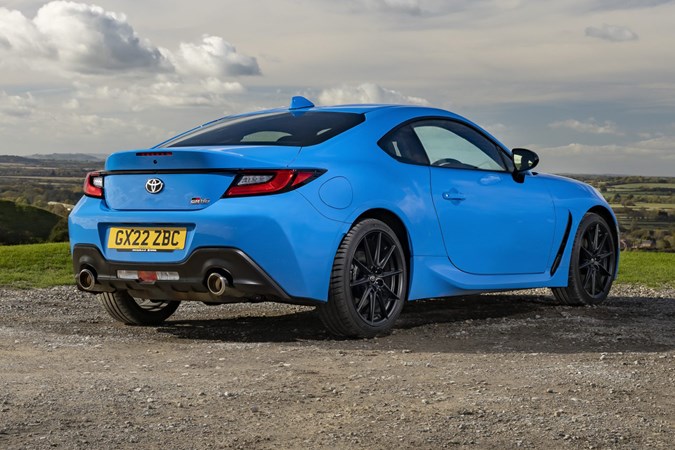 Toyota GR86 review: rear three quarter static, low angle, parked on gravel, blue paint