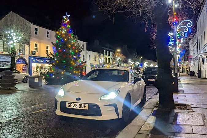 Toyota GR86 long-term review: front three quarter static, in front of a Christmas tree in Cockermouth, white paint