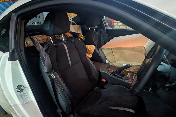 Toyota GR86 long-term review: front seats, box on passenger seat, rear seats folded flat and piled high with stuff