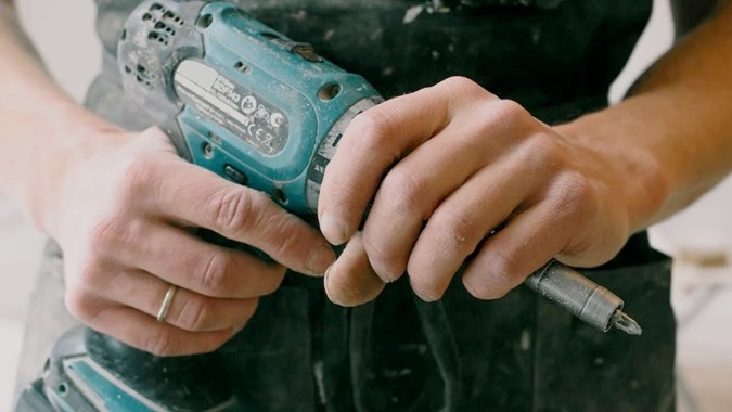 person holding a drill