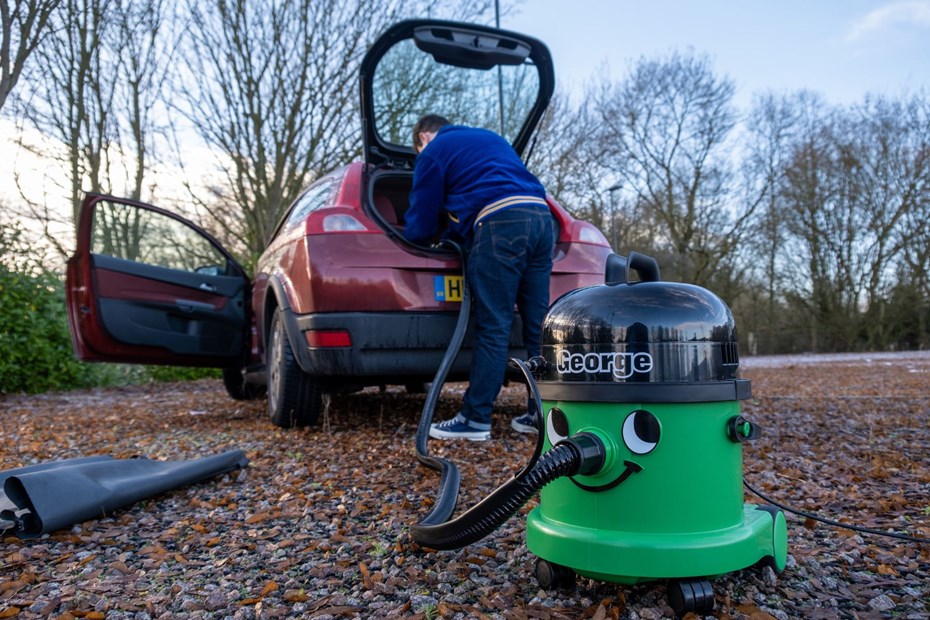 The George vacuum cleaner being used to clean a car