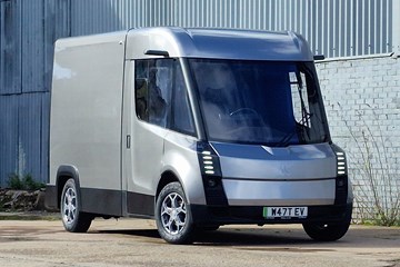 WEVC eCV1 front three quarter static, parked behind an industrial unit, silver paint