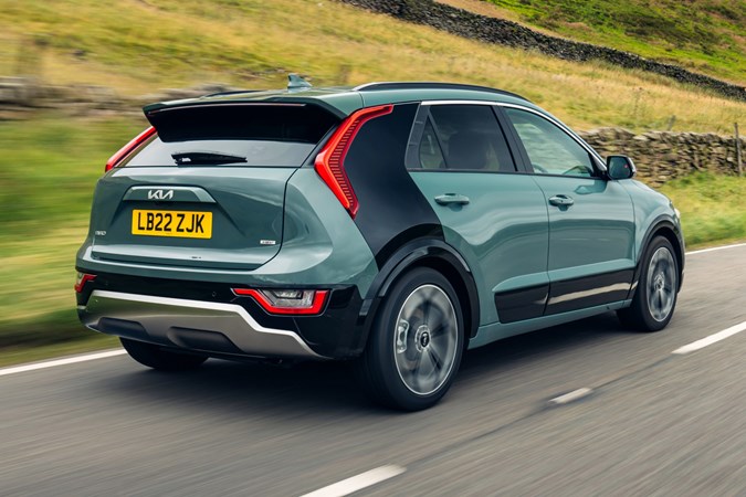 Kia Niro Hybrid, rear three quarter driving, green paint