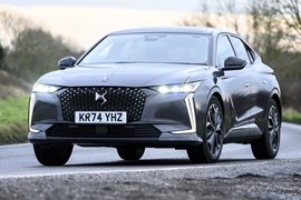 Image of a DS 4, in grey, driving round a right-hand corner, viewed from the car's front left corner