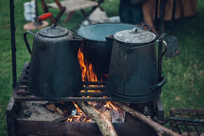 Kettles on a barbecue fire