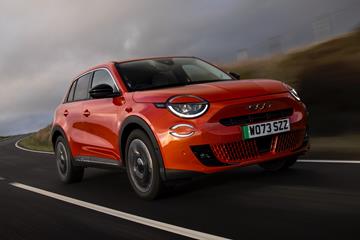 Fiat 600e review (2023): front three quarter driving, orange paint