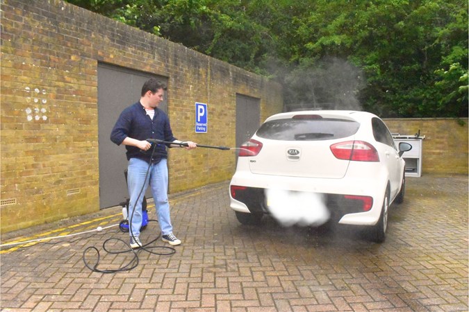 Ryan Gilmore cleaning a Kia Rio with Nilfisk pressure washer