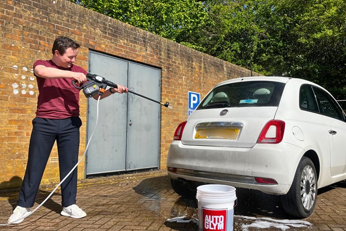 Ryan Gilmore cleans a white Fiat with the Worx Nitro, Parkers' favourite cordless pressure washer