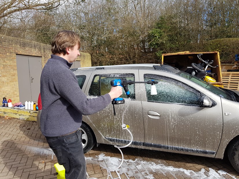 Aaron Hussain cleans car with cordless pressure washer