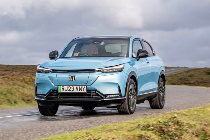 Honda e:Ny1 review - front, blue, driving round corner