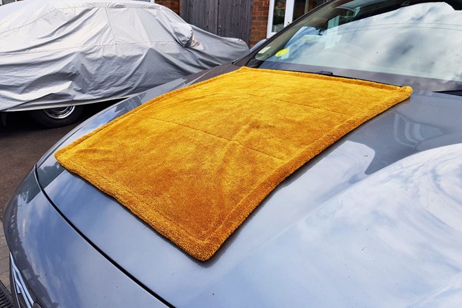 Drying towel on bonnet of Volvo spread out