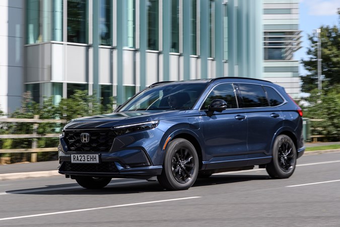 Honda CR-V long-term test, front, blue, driving by office building