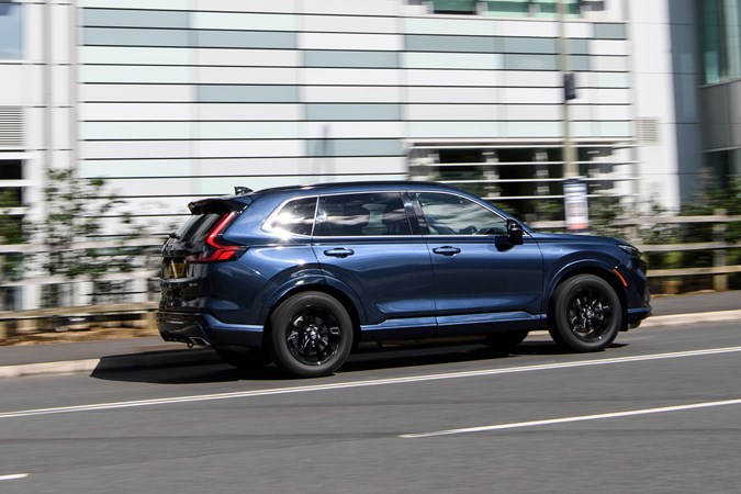 Honda CR-V long-term test, rear, blue, driving by office building