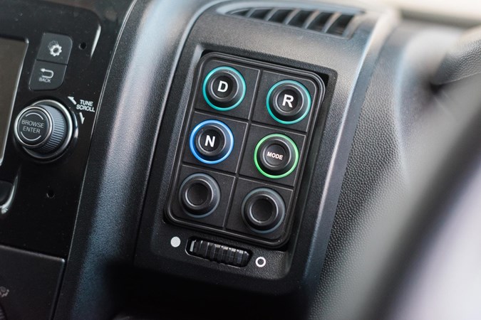 The additional buttons on the RE-100's dash look neatly integrated.