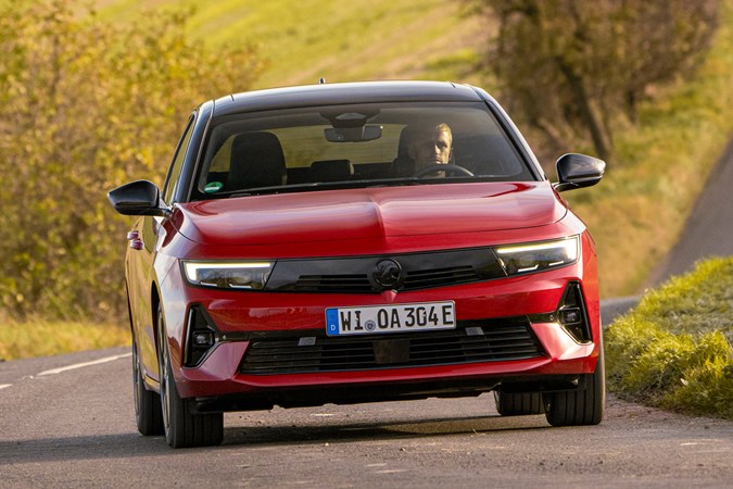 Vauxhall Astra Sports Tourer Electric (2023) review: front cornering, British country lane, red paint