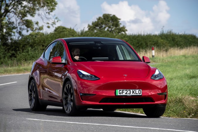 Tesla Model Y: safest cars in the UK 2023, front three quarter cornering, red paint