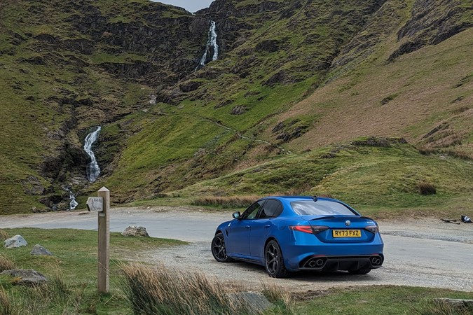 Alfa Romeo Giulia QV: rear three quarter static, on a Cumbrian fell road, blue paint