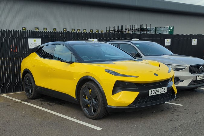 Lotus Eletre: front three quarter static, in a car park, yellow paint