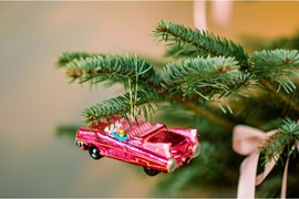 A selection of Christmas gifts on a red background