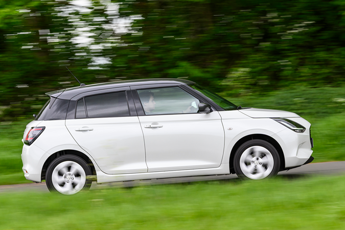 Suzuki Swift long term test car, white, motion, side on | Parkers