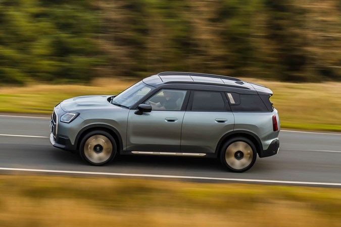 MINI Countryman (2024) review: side view driving, high angle, silver paint, British country road