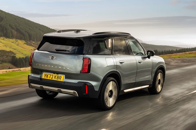 MINI Countryman (2024) review: rear three quarter driving, high angle, silver paint, British country road