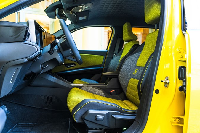 Renault 5 E-Tech (2024) review: front seats and steering wheel, yellow and black fabric upholstery