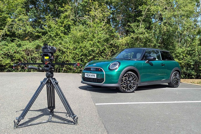 MINI Cooper S long-term test: front three quarter static, green paint, next to a digital camera on a tripod