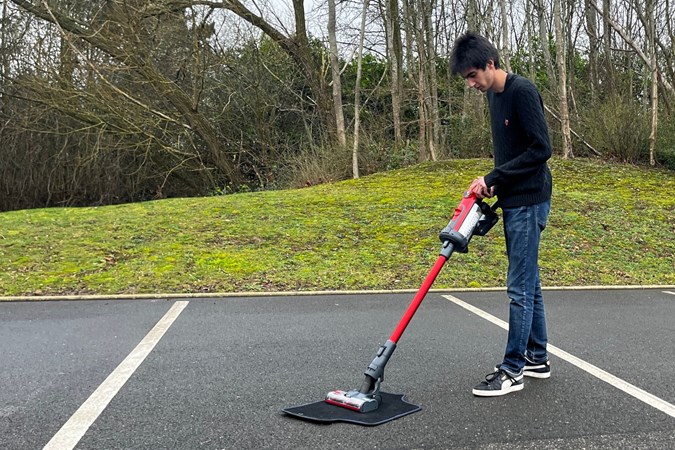 The Henry Quick in upright mode cleaning a car floor mat