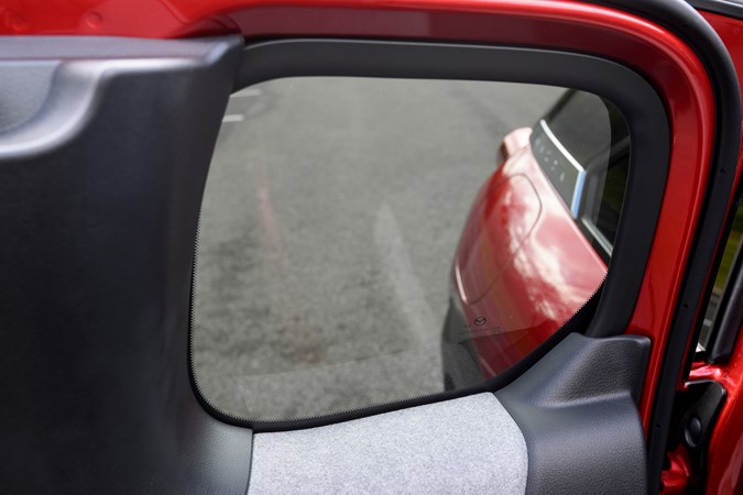 The rear windows on the Mazda MX-30 are tiny and tinted, which means back seat passengers don't get a lot of light or much visibility of what's going on outside the car