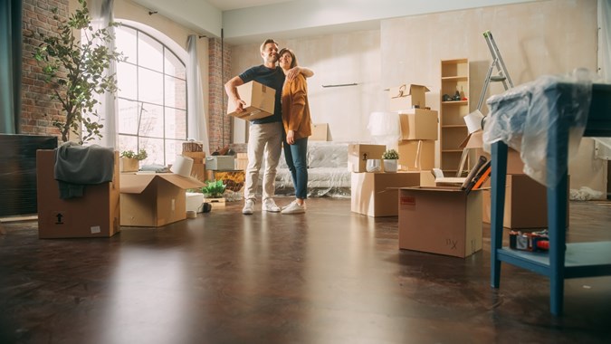 Happy couple moving into new home - How to renew driving license