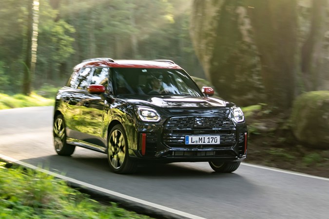 MINI Countryman JCW (2024) review: front three quarter cornering, black and red paint