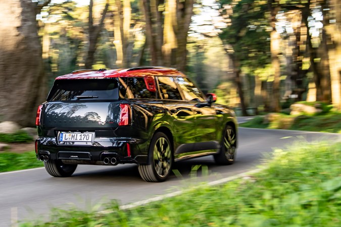 MINI Countryman JCW (2024) review: rear three quarter cornering, black and red paint