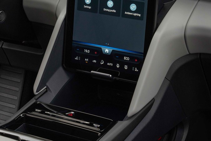 Ford Explorer review: infotainment screen, in highest position, revealing storage storage tray