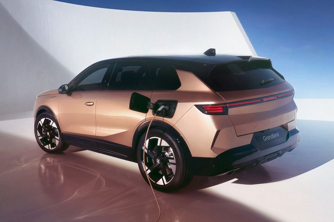 New 2024 Vauxhall Grandland unveiled: rear three quarter static, bronze paint, plugged in charging, studio shoot