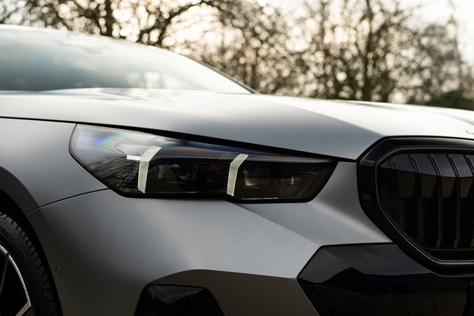 BMW 5 Series review: LED headlight detail shot, matte grey paint