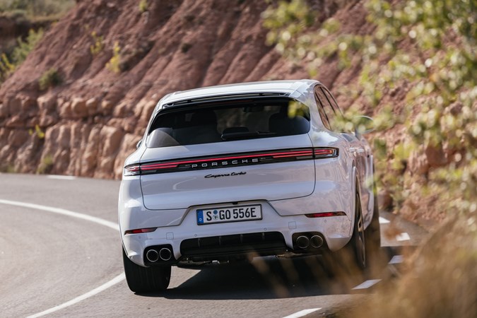 Porsche Cayenne review - 2023 facelift - Turbo E-Hybrid, white, rear, driving round corner