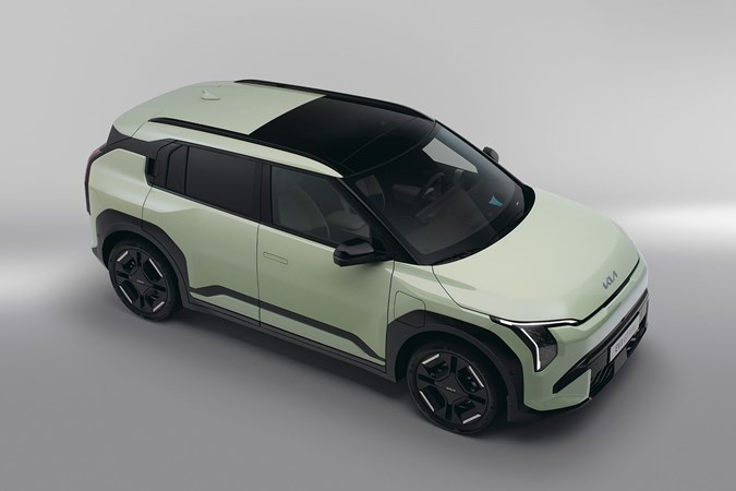Kia EV3 (2024) reveal: rear three quarter static, high angle, green paint, studio shoot