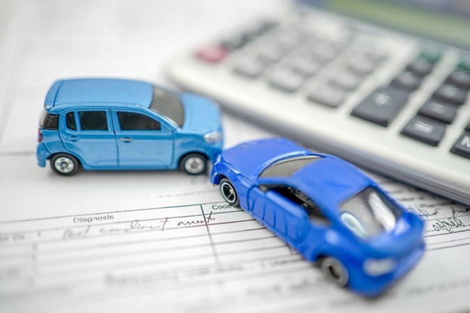 Toy cars on document - Reduce car running costs