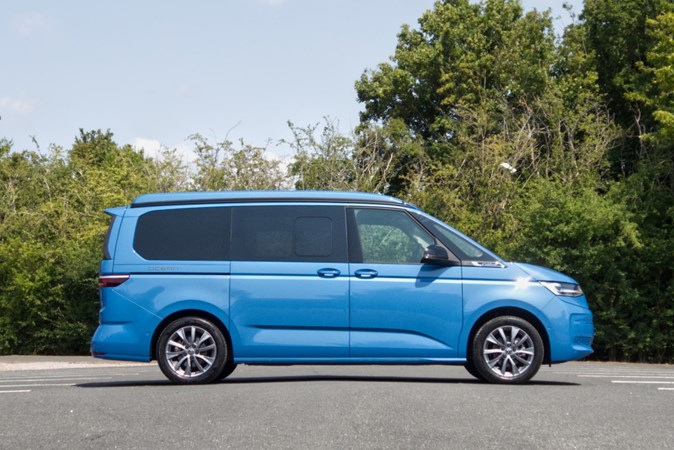 Image of a static, blue Volkswagen California, viewed from the right side