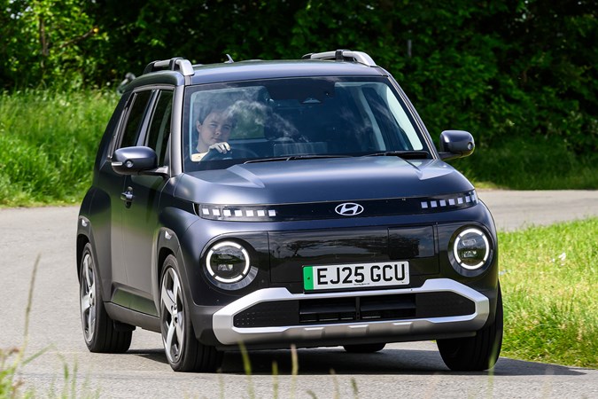 Hyundai Inster review, black, exterior, moving, front three quarters | Parkers