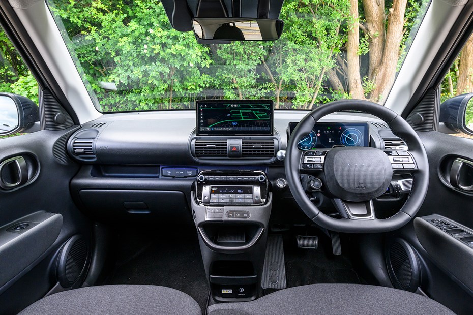 Hyundai Inster review, black, interior, dashboard, steering wheel | Parkers