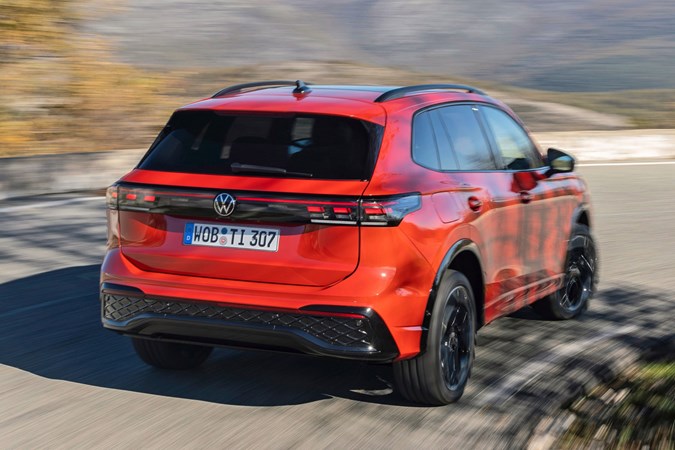 Volkswagen Tiguan eHybrid review - rear, orange, driving round corner