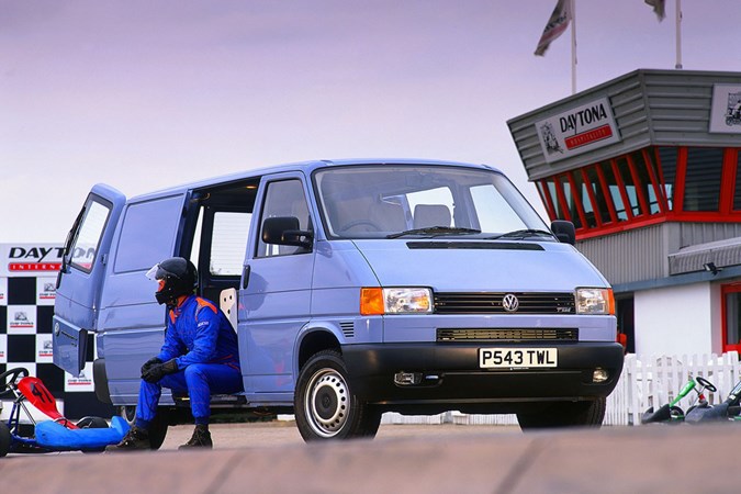 Image of Volkswagen T4 Transporter panel van in blue, with person sat in open side door